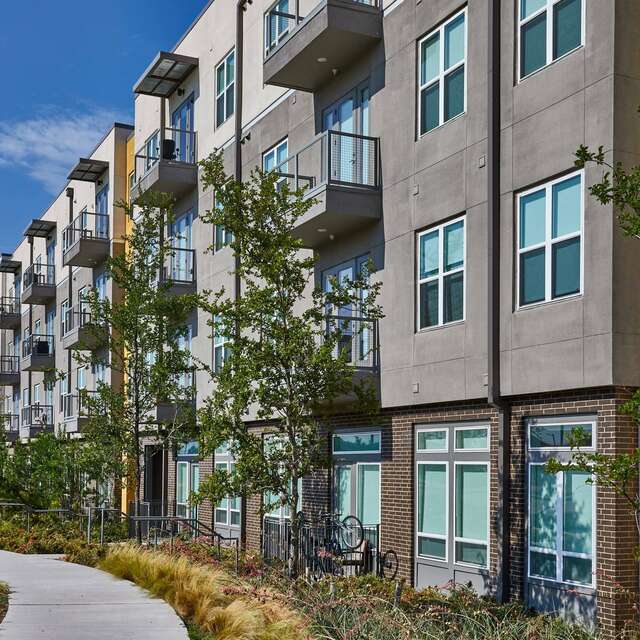 Tree lined exterior of the Standard at Cityline with a walking a path.