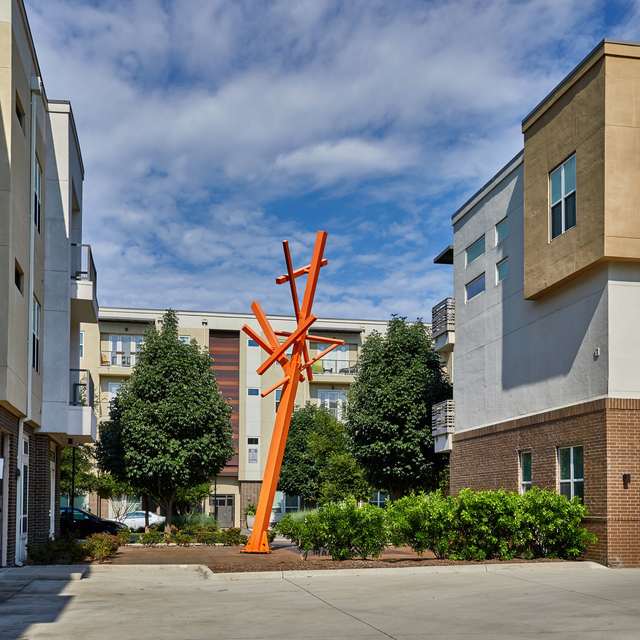 The standard at Cityline community exterior with a large orange sculpture