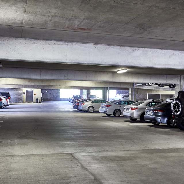 Multi-level parking garage with parked cars in it