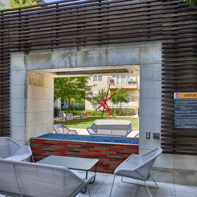 Community courtyard with lounge seating and a feature fireplace