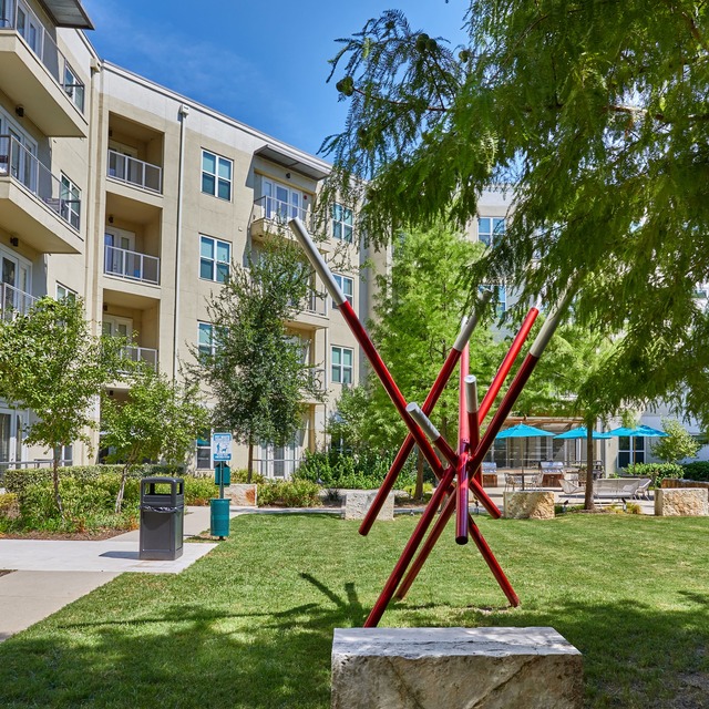 Community exterior and courtyard with a large red sculpture