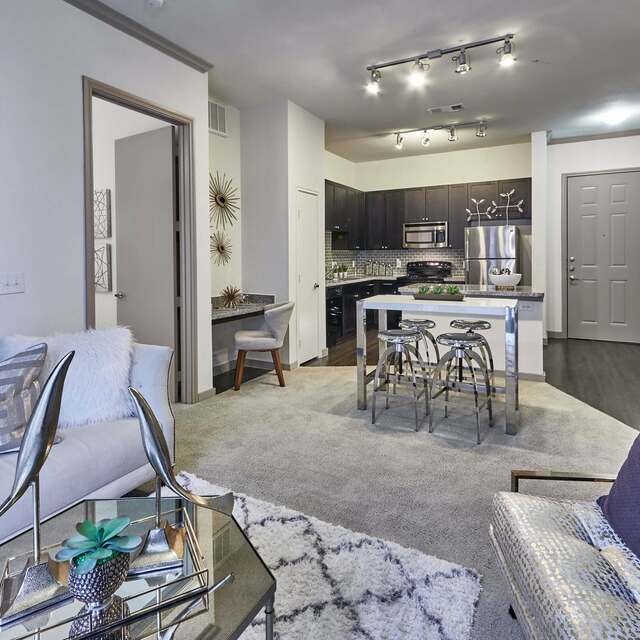 Carpeted living room and dining area