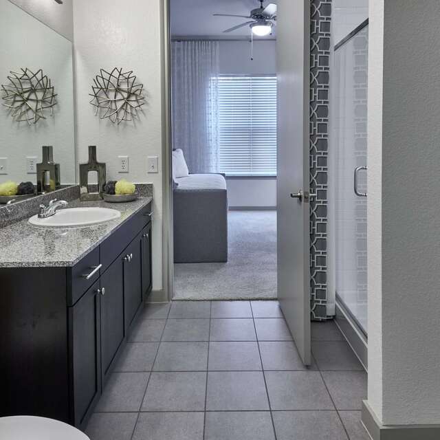 Bathroom with tile flooring and a large single sink vanity