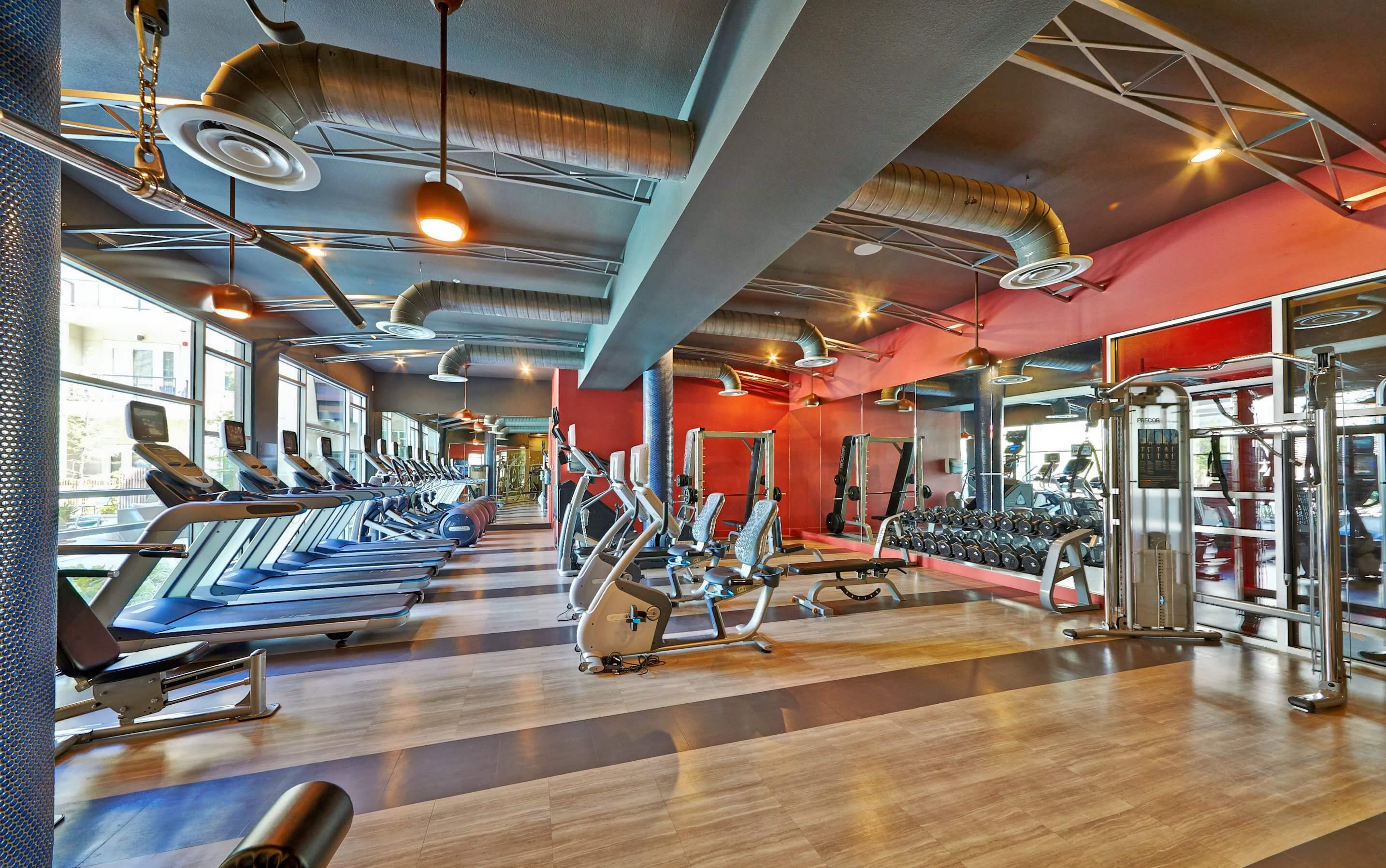 Fitness center with treadmills, bikes, free weights, and weight machines