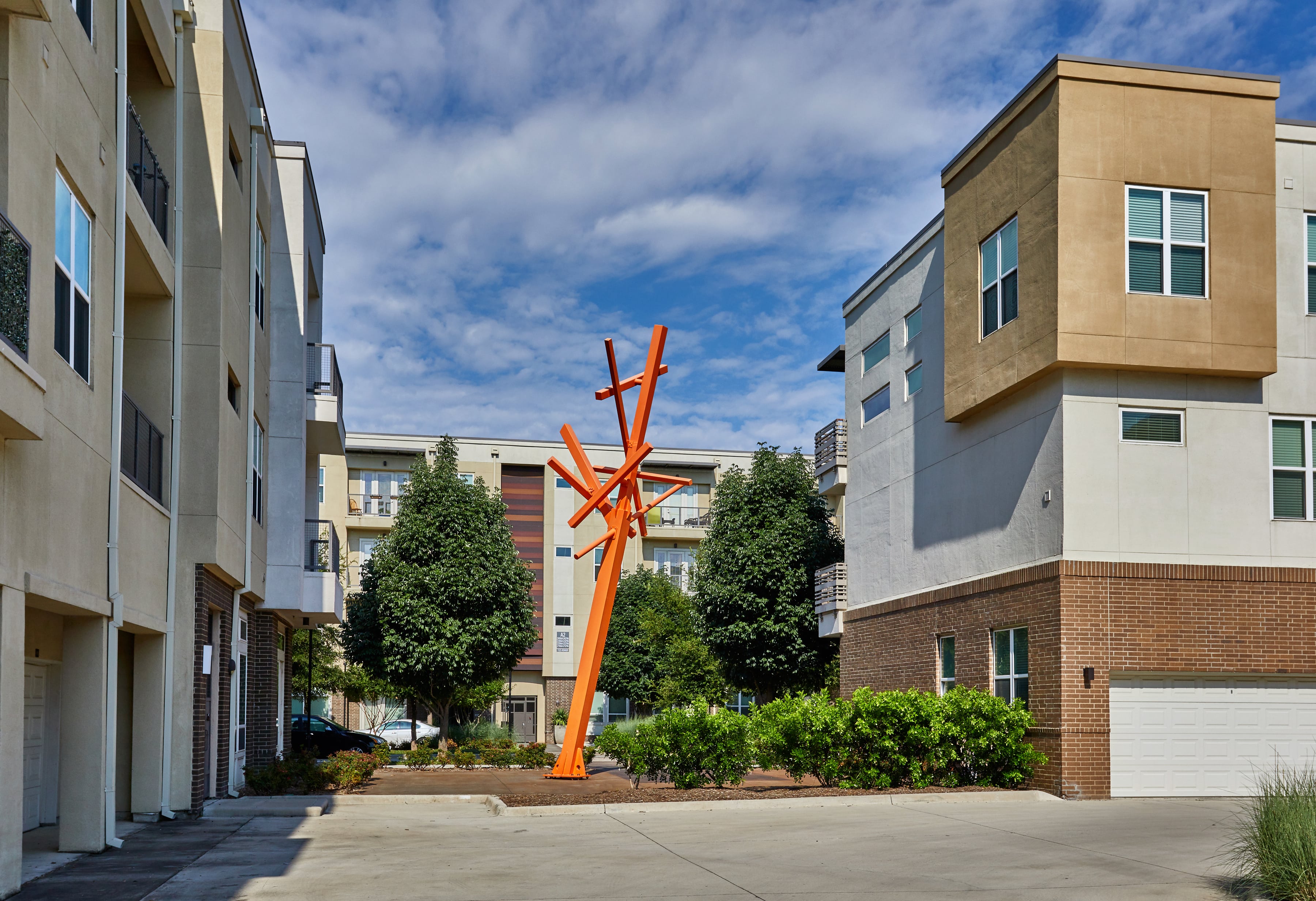 The standard at Cityline community exterior with a large orange sculpture