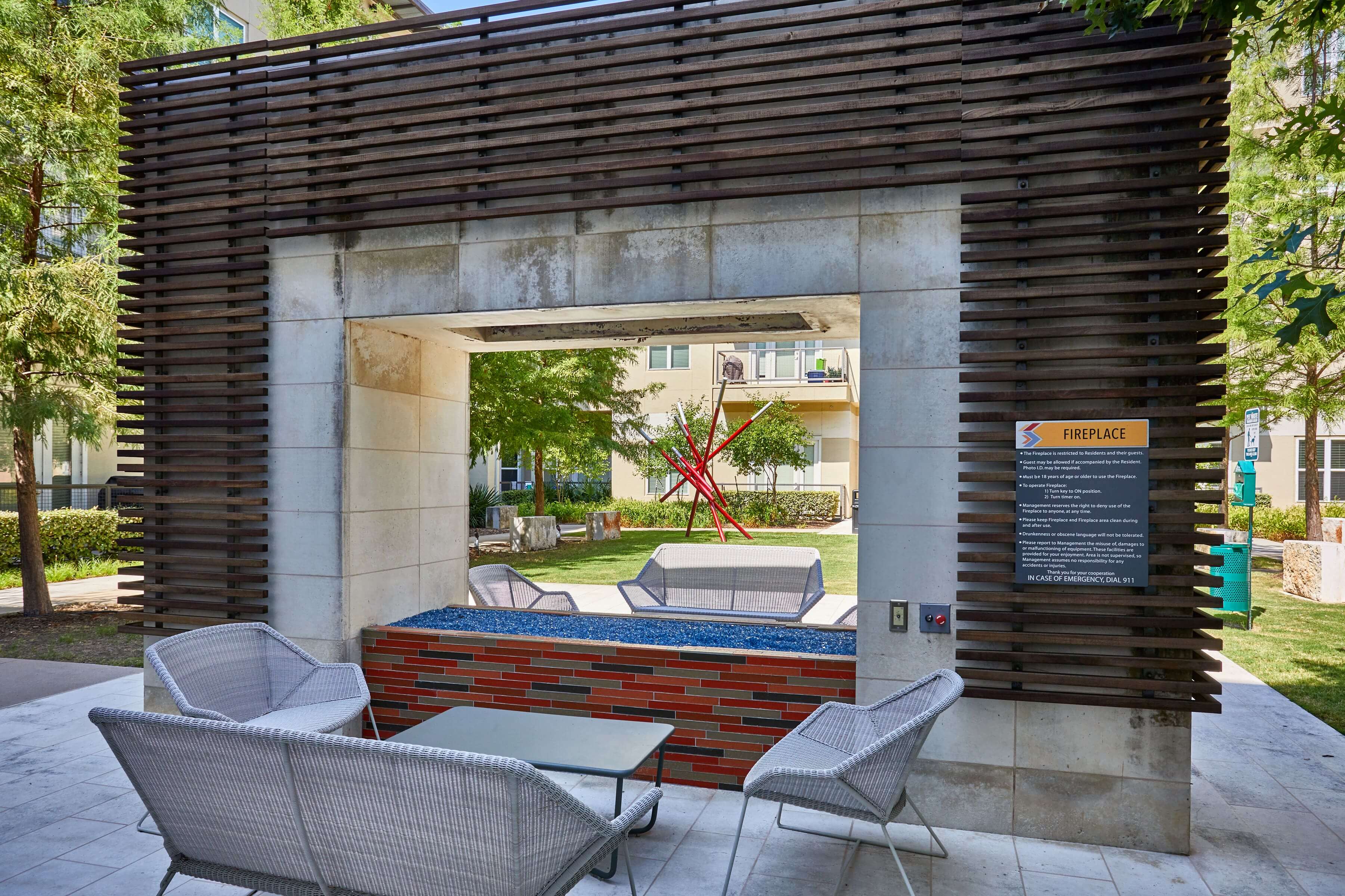 Community courtyard with lounge seating and a feature fireplace