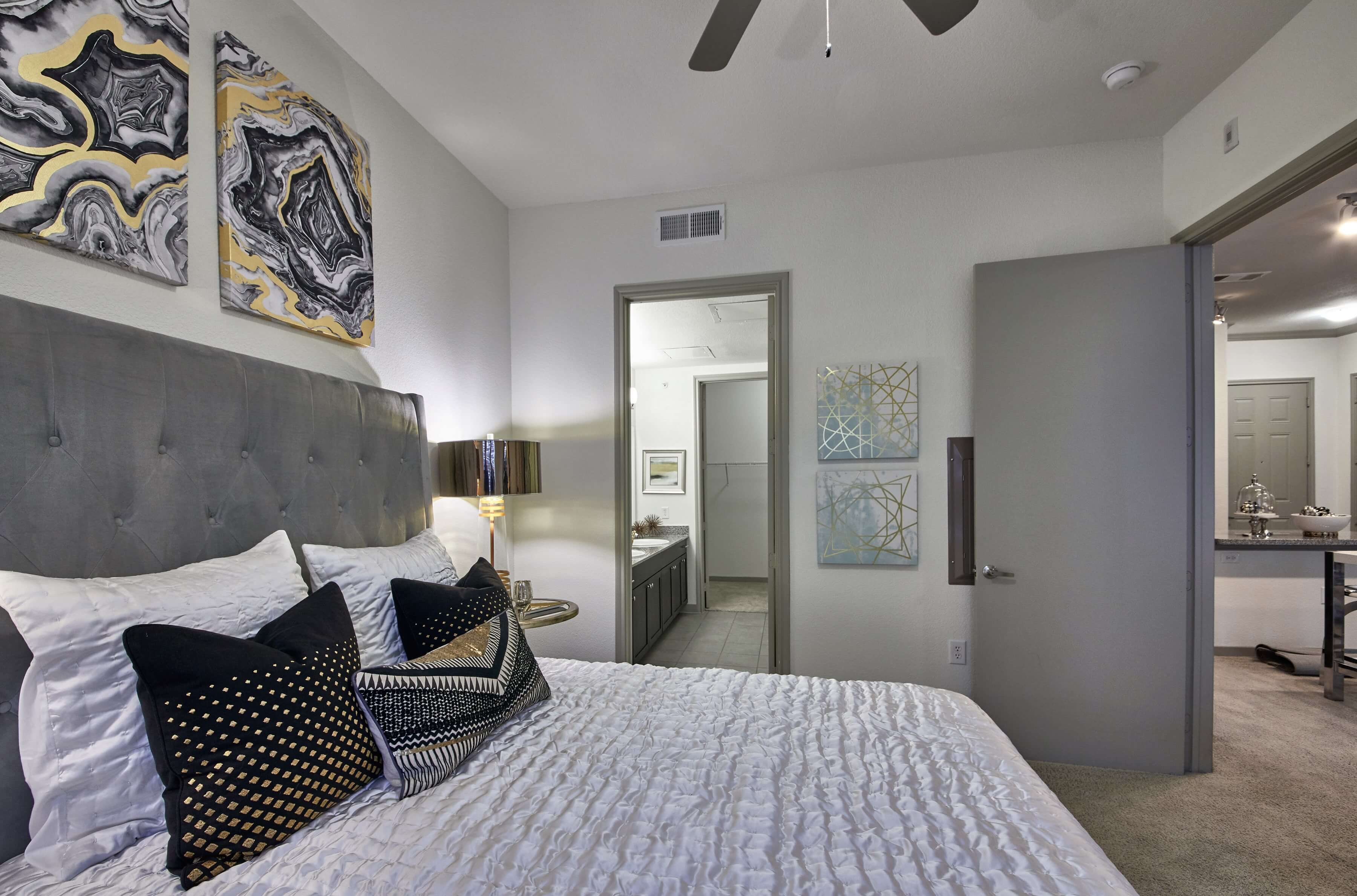 Bedroom en-suite with a large bed and artwork on the walls